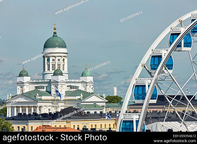 Ferris wheel and Cathedral of the Diocese of Helsinki, finnish Evangelical Lutheran church, located in the neighborhood of Kruununhaka in Helsinki, Finland