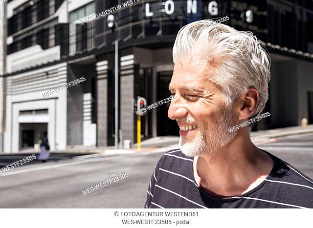Portrait of a mature man, walking in the city