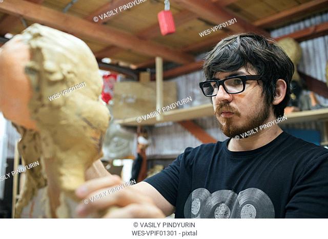 Sculptor working on a bust