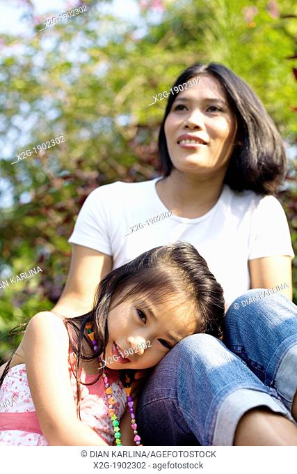 Mother and daughter playing in a garden