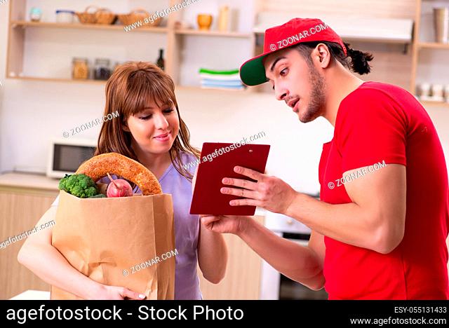 Young male courier in food delivery concept
