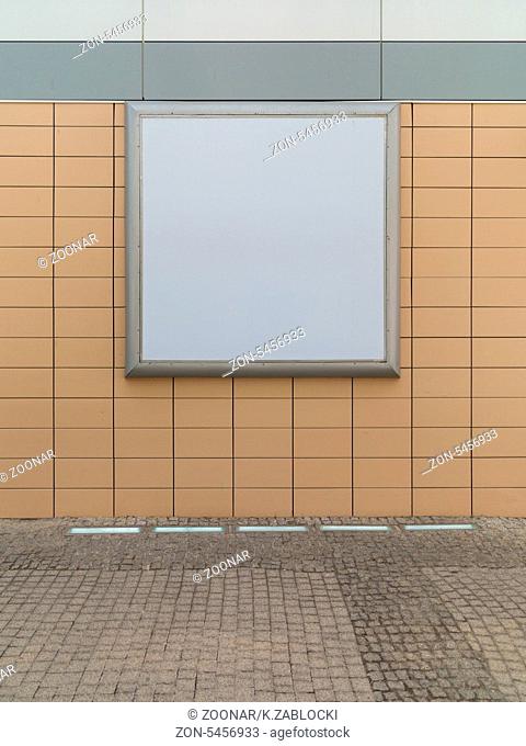 Empty blank square white advertising billboard on orange tiled wall. Information. Promotion of your product. Real