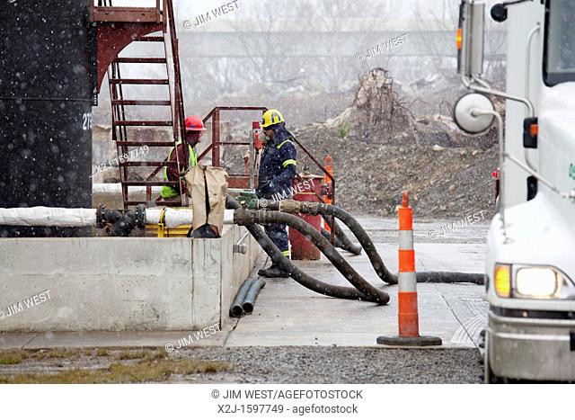 Youngstown, Ohio - Workers unload hydraulic facturing fracking fluids from a tank truck at an injection well where the toxic waste will be pumped deep...