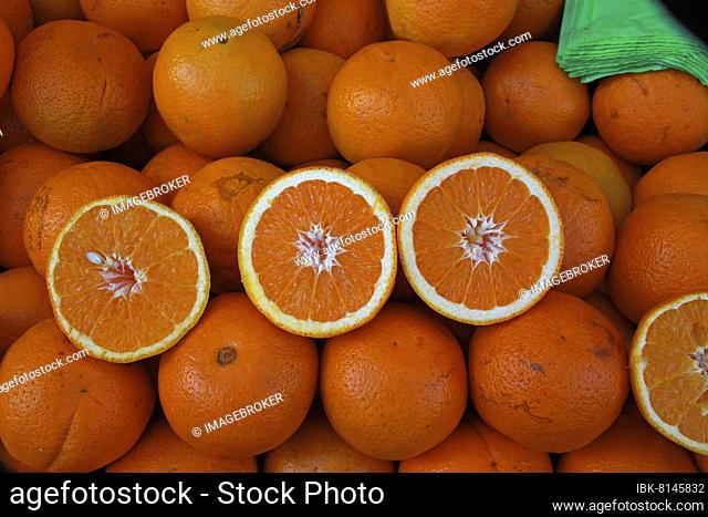 Several oranges with halved fruits and plastic bags, oranges on market, Andalusia, Spain, Europe