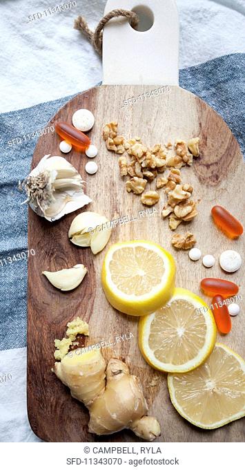 Lemon, ginger, garlic and tablets on a chopping board