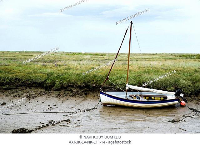 Fishing boat in mud of small estuary near Stiffkey, Norfolk, England