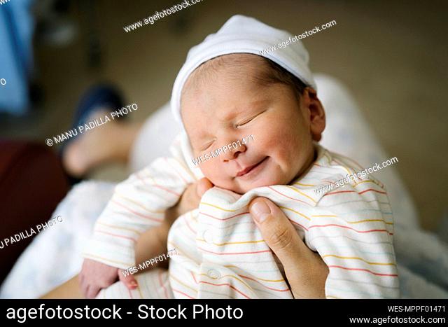 Woman holding newborn baby boy