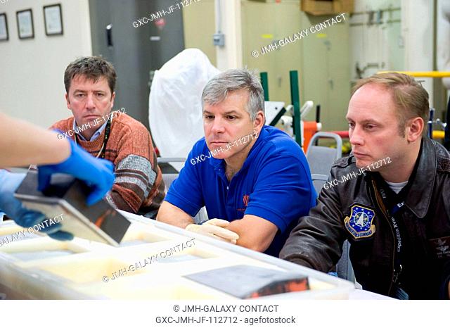 NASA astronauts Gregory H. Johnson (center), STS-134 pilot; and Michael Fincke (right), mission specialist; along with European Space Agency astronaut Roberto...