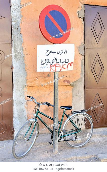 bicycle chained up at no parking sign, Morocco, Marrakesh