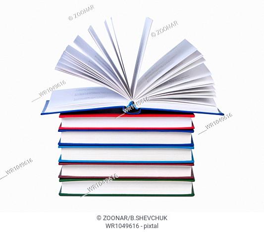 Open book on stack of books isolated