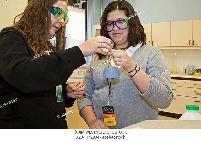 Detroit, Michigan - Laura Torres right, a ninth-grade student, with chemistry teacher Caitie O'Connell at Cristo Rey High School  Students at Cristo Rey are in...