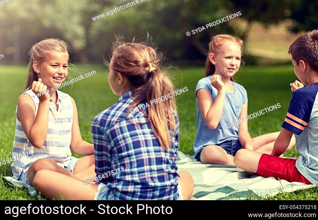 happy kids playing rock-paper-scissors game