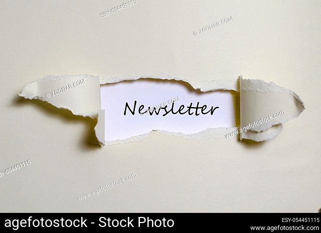 The word newsletter appearing behind torn paper