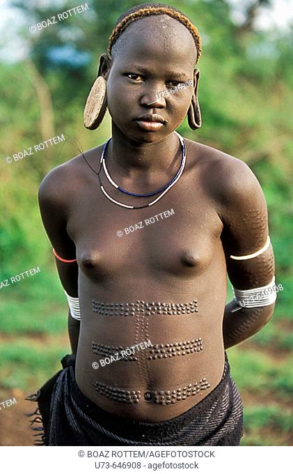 Beautiful girl of the Mursi tribe in the lower omo valley, Ethiopia.
Lots of detail of the art of the body scarring they do