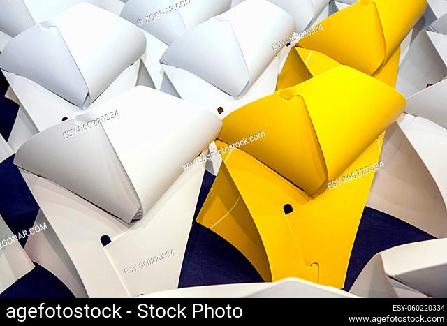 rows of white and yellow creative paper seat place, closeup