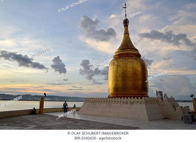 Burmese visitors and pilgrims at the gilded Bupaya Pagoda on the Ayeyarwady river at dusk, Old Bagan, Pagan, Burma, Myanmar, Southeast Asia, Asia