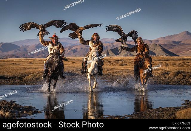 Mongolian eagle hunter, three Kazakhs on horseback with trained eagles, Bajan-Ölgii province, Mongolia, Asia