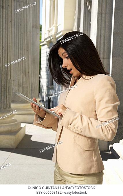 businesswoman with tablet portrait between big columns