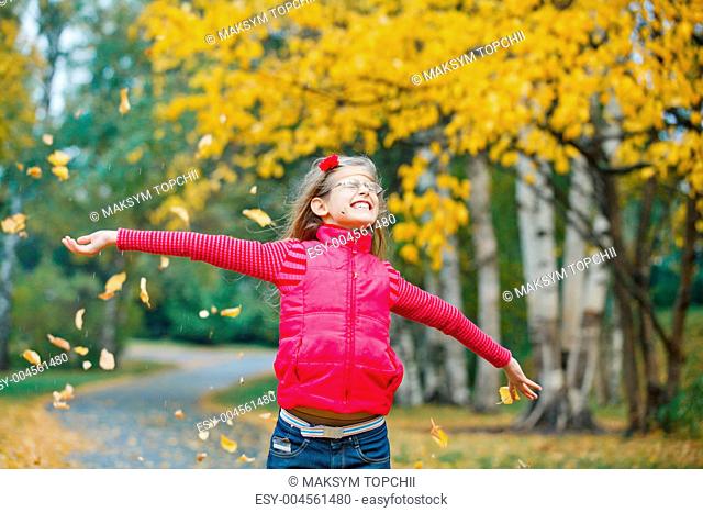 Cute girl walking in the autumn park