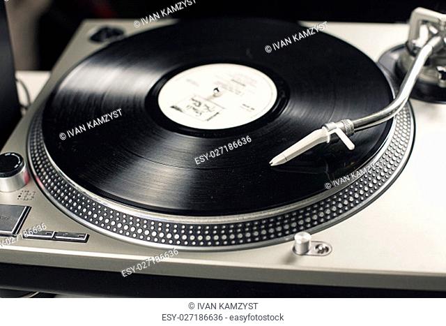 DJ mixer with a vinyl record, close up