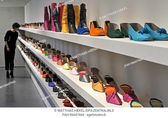 A visitor admires a collection of paper women's shoes in the ""Supermarket of the Dead"" exhibition at the Residenzschloss Dresden, Germany, 13 March 2015