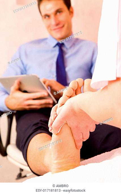Businessman receiving foot massage from therapist