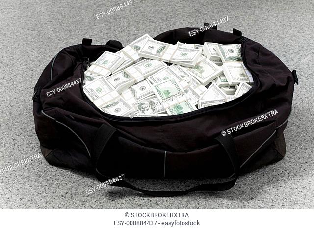 Image of big bag full of American dollars on the floor