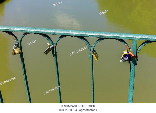 Love padlocks locked at bridge guardrail Strasbourg Alsace France