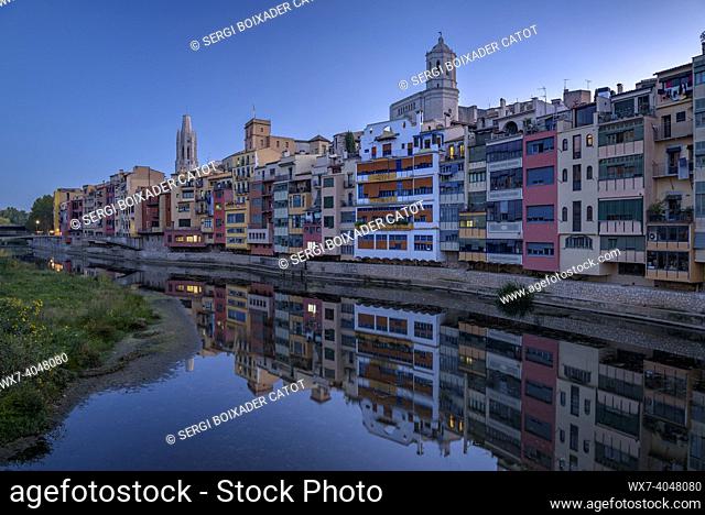 Houses next to the Onyar river as it passes through the city of Girona at blue hour (Girona, Catalonia, Spain)