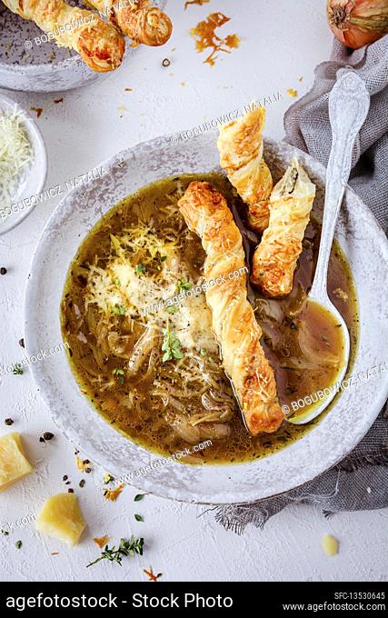 French onion soup with Parmesan cheese and puff pastry fingers