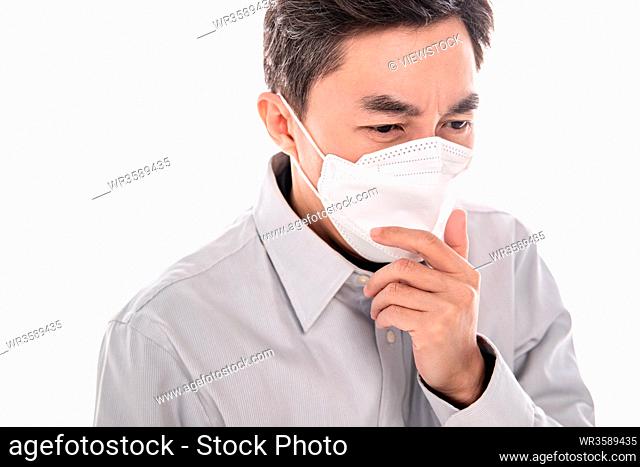 Sick middle-aged man wearing a mask