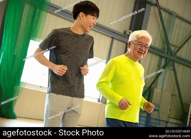 Senior and young people jogging with smile