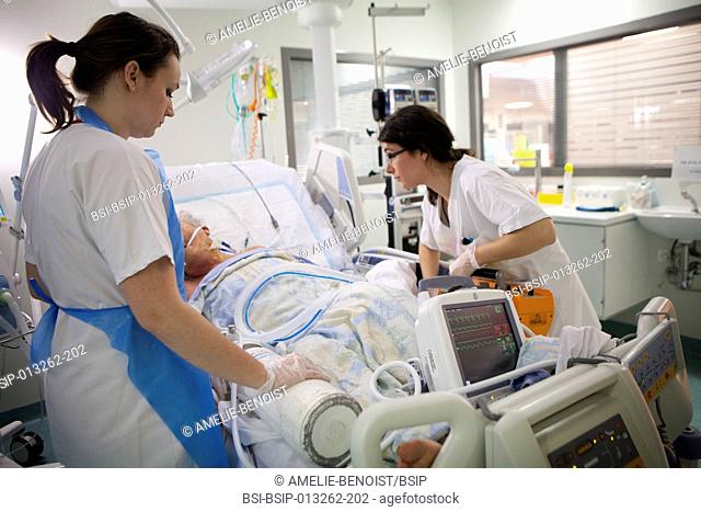 Reportage in Robert Ballanger hospital's Intensive Care Unit in France. An intern and a nurse get a patient ready to be taken to the radiology service