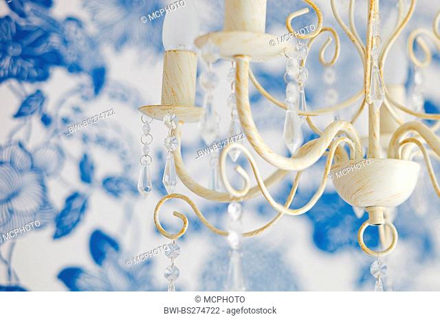 vintage chandelier in front of white-and-blue background