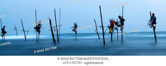 Fishermen perched on their stilts in Midigama, Sri Lanka