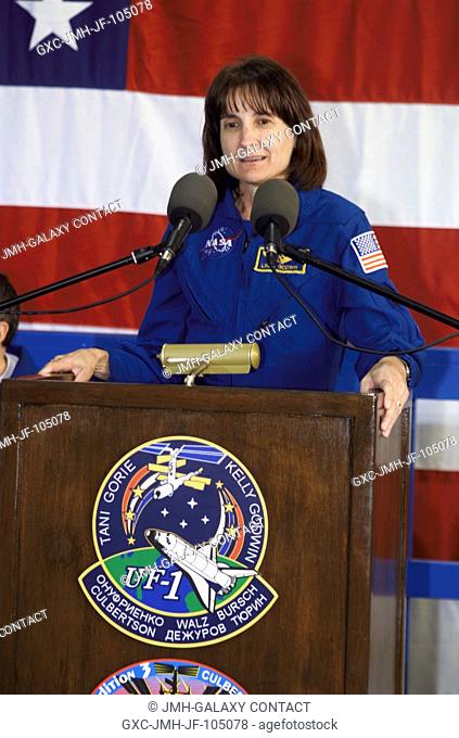 Astronaut Linda M. Godwin, STS-108 mission specialist, speaks from the podium in Hangar 990 at Ellington Field during the STS-108 and Expedition Three crew...