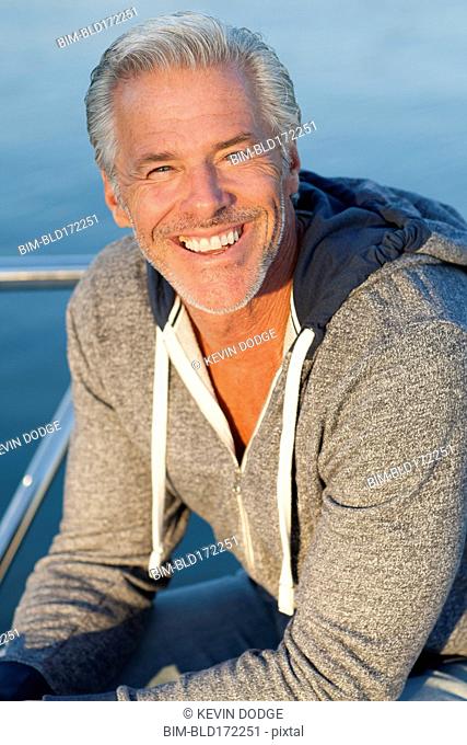 Caucasian man smiling on boat deck