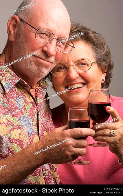 Happy Senior Couple toasting with wine glasses