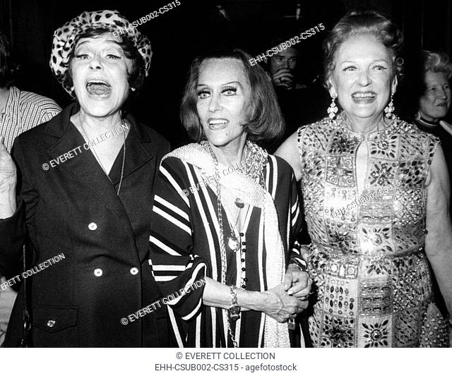 Gloria Swanson (center) with actress Fifi d'Orsay (left) and silent screen actress Carmel Myers. Swanson was giving a Schubert Alley party following her opening...