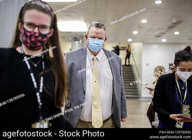 Senator Jon Tester, a Democrat from Montana, wears a protective mask while walking through the Senate Subway at the U.S. Capitol in Washington, D.C