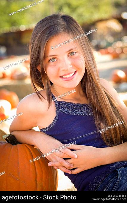 Preteen Girl Portrait at the Pumpkin Patch in a Rustic Setting