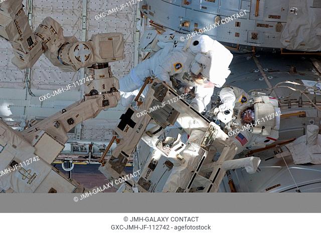 With various components of the International Space Station serving as a backdrop in the view, NASA astronauts Andrew Feustel (right) and Michael Fincke are...