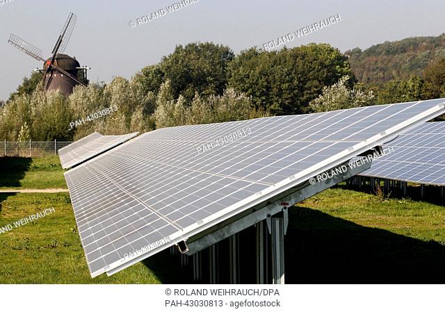Solar cell panels of energy provider ENNI stand in front of an old windmill in Moers, Germany, 30 September 2013. The solar park with its 14