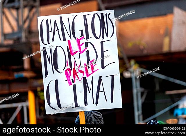 French sign seen in an ecological protest saying let's change the world, not the climate