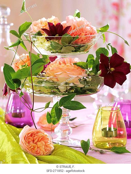 Layered stand composed of two glass bowls with roses & clematis