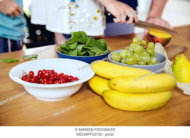 Close-up of family cutting fruit on kitchen counter