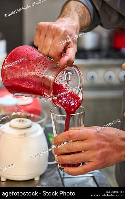 Serving fruit juice with beetroot from a crystal pitcher