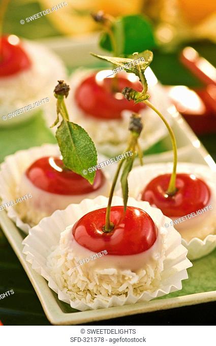 Chocolate-dipped cherries with grated coconut
