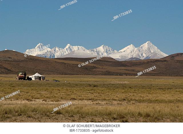 Nomadic tent with a Chinese truck in front of the mighty peaks of the snow-capped Himalayan main ridge, Ngari Province, Western Tibet, Himalayas, Tibet, China
