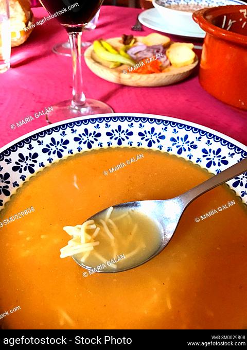 Eating cocido soup. Madrid, Spain